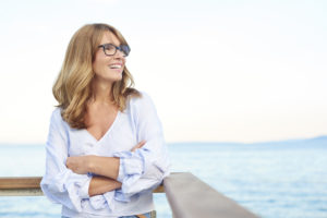 Woman on balcony looking into the ocean